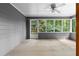 Cozy carpeted sunroom with ceiling fan and large screened windows overlooking a backyard at 2865 Bryant Ct, Cumming, GA 30040