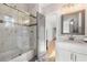 Bathroom with white marble tile, glass shower door and modern vanity mirror at 704 Rock Springs Rd, Lawrenceville, GA 30043