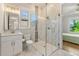 Modern bathroom with marble tile, glass-enclosed shower, and natural light and a view to another bedroom at 704 Rock Springs Rd, Lawrenceville, GA 30043
