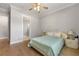 Bright bedroom features hardwood floors and a ceiling fan at 704 Rock Springs Rd, Lawrenceville, GA 30043