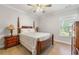 Cozy bedroom features hardwood floors, lamps, and natural light from the window at 704 Rock Springs Rd, Lawrenceville, GA 30043