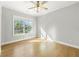Bright and empty bedroom features hardwood floors and a large window at 704 Rock Springs Rd, Lawrenceville, GA 30043