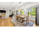 Open concept dining room and living room features hardwood floors and a view of the backyard at 704 Rock Springs Rd, Lawrenceville, GA 30043