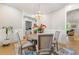 Beautiful dining area featuring a modern chandelier, wood floors, and view to living room at 704 Rock Springs Rd, Lawrenceville, GA 30043
