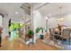 Inviting open-concept dining area featuring wood floors, modern lighting, and a staircase to upper floor at 704 Rock Springs Rd, Lawrenceville, GA 30043