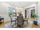 Elegant dining room with a modern chandelier and large windows overlooking a well-maintained lawn at 704 Rock Springs Rd, Lawrenceville, GA 30043