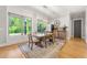 Bright dining room with large windows, stylish light fixture, and hardwood floors is great for entertaining at 704 Rock Springs Rd, Lawrenceville, GA 30043