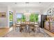 Well-lit dining room featuring hardwood floors, large windows, and a view of the lush green landscape at 704 Rock Springs Rd, Lawrenceville, GA 30043