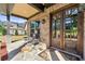 Inviting front porch with stone flooring, rocking chairs, and a view of the well-maintained front yard at 704 Rock Springs Rd, Lawrenceville, GA 30043