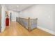 Upstairs hallway with wrought iron railing and beautiful hardwood floors at 704 Rock Springs Rd, Lawrenceville, GA 30043