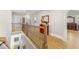 Upstairs hallway with wrought iron railing, hardwood floors and beautiful natural light at 704 Rock Springs Rd, Lawrenceville, GA 30043