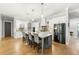 Modern kitchen featuring a large center island with seating, pendant lighting, and stainless steel appliances at 704 Rock Springs Rd, Lawrenceville, GA 30043