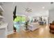 Spacious open-concept living room features hardwood floors, a fan and access to the covered outdoor space at 704 Rock Springs Rd, Lawrenceville, GA 30043