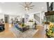Spacious living room with fireplace flows into kitchen with a central staircase featuring wrought iron spindles at 704 Rock Springs Rd, Lawrenceville, GA 30043