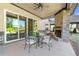 Covered patio with stone fireplace, ceiling fan, and outdoor dining area at 704 Rock Springs Rd, Lawrenceville, GA 30043