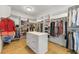 Organized walk-in closet featuring custom shelving and central island for storage at 704 Rock Springs Rd, Lawrenceville, GA 30043