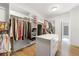 Well-organized walk-in closet featuring custom shelving and a central storage island at 704 Rock Springs Rd, Lawrenceville, GA 30043
