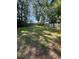 Spacious backyard with mature trees, offering privacy and shade at 710 Singing Hills Ct, Roswell, GA 30076