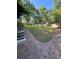 Backyard features a large grassy area and a brick patio area for outdoor enjoyment at 710 Singing Hills Ct, Roswell, GA 30076