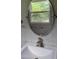 Bathroom featuring unique tile, an oval mirror, and a white sink at 710 Singing Hills Ct, Roswell, GA 30076