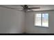 Bright bedroom featuring a ceiling fan, fresh paint, window, and modern flooring at 710 Singing Hills Ct, Roswell, GA 30076