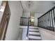 Inviting entryway showcasing elegant black railings, chandelier, and a glimpse of the kitchen at 710 Singing Hills Ct, Roswell, GA 30076
