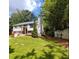 Charming two-story home featuring a well-manicured front lawn and classic architectural design at 710 Singing Hills Ct, Roswell, GA 30076