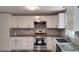 Modern kitchen featuring granite counters, stainless steel appliances, and white cabinetry at 710 Singing Hills Ct, Roswell, GA 30076