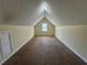 Spacious attic with a window, neutral walls, and carpet flooring at 1050 Redan Trce, Stone Mountain, GA 30088