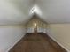 View of attic with neutral walls, carpet flooring, and entrance doorway at 1050 Redan Trce, Stone Mountain, GA 30088