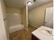 Bathroom with a single sink vanity and tub at 1050 Redan Trce, Stone Mountain, GA 30088