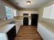 Functional kitchen featuring white cabinets, black appliances and ample counter space at 1050 Redan Trce, Stone Mountain, GA 30088