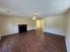 Spacious living room with wood flooring, fireplace, and fan offers ample space for relaxation at 1050 Redan Trce, Stone Mountain, GA 30088