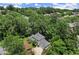Aerial view of a charming gray two-story home nestled among lush, mature trees at 1050 Shady Valley Pl, Atlanta, GA 30324