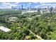 Aerial view of the Buckhead community featuring mature trees, homes, and the Atlanta skyline in the background at 1050 Shady Valley Pl, Atlanta, GA 30324