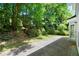 Backyard space with a paved area, lush greenery and the side of the house with window at 1050 Shady Valley Pl, Atlanta, GA 30324