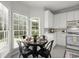 Cozy breakfast nook featuring a round table, modern lighting, and large windows offering natural light and serene outdoor views at 1050 Shady Valley Pl, Atlanta, GA 30324