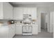 Bright kitchen with white cabinets, stainless steel appliances, and a functional layout for efficient cooking and meal preparation at 1050 Shady Valley Pl, Atlanta, GA 30324