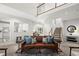 Bright living room with an open floor plan, cozy seating, stairs leading to an upper level, and views to a kitchen at 1050 Shady Valley Pl, Atlanta, GA 30324