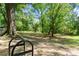 Park area with a bike rack surrounded by green grass and mature trees at 1050 Shady Valley Pl, Atlanta, GA 30324