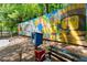 Outdoor park area featuring mural art, a bench, and a little blue lending library at 1050 Shady Valley Pl, Atlanta, GA 30324