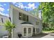 Two-story home exterior boasting large windows and a door with an adjacent patio area at 1050 Shady Valley Pl, Atlanta, GA 30324