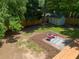 This backyard features a cozy seating area, lush greenery, wooden fence and a storage shed at 2272 Desmond Dr, Decatur, GA 30033