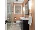 Cozy bathroom featuring a glass shower, single vanity, and decorative mirror at 2272 Desmond Dr, Decatur, GA 30033