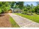 Charming single-story home featuring a welcoming front porch, beautifully landscaped yard, and a long driveway at 2272 Desmond Dr, Decatur, GA 30033