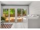 Bright sun room featuring laundry area, tile floors, sliding glass doors, and charming decor at 2272 Desmond Dr, Decatur, GA 30033