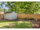 This backyard features a storage shed, wooden fence and lush greenery at 2272 Desmond Dr, Decatur, GA 30033