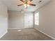 This bedroom features a ceiling fan and large windows allowing for natural light to illuminate the room at 4544 Parkview Sq, Atlanta, GA 30349