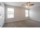 This bedroom features two windows allowing for natural light and a ceiling fan for added comfort at 4544 Parkview Sq, Atlanta, GA 30349