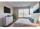 Cozy bedroom featuring bright natural light, a modern TV, and ample closet space at 4544 Parkview Sq, Atlanta, GA 30349
